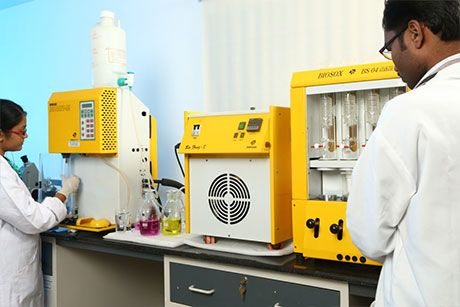 Lab technicians testing spice samples on analytical equipment